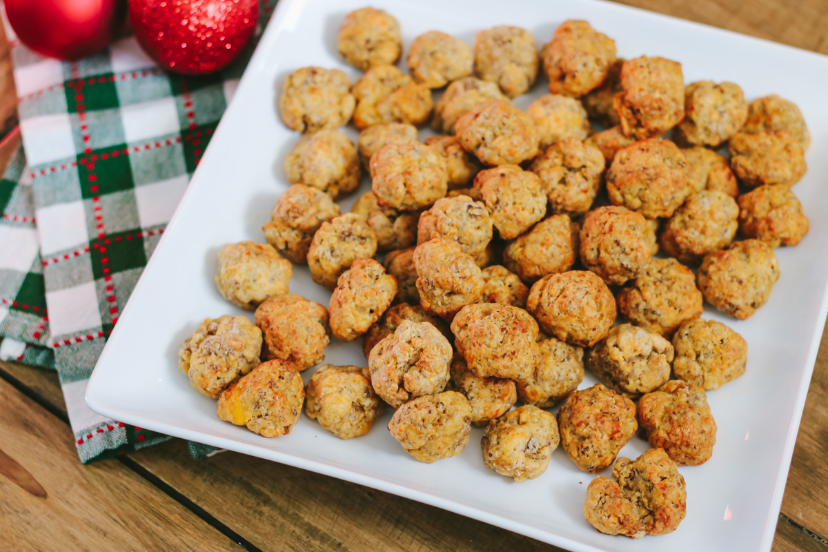 My sausage balls recipe made with Bisquick, pork sausage and cheddar is a favorite holiday appetizer and a big hit with guests. They continue to be one of my most-requested holiday recipes! Serve sausage balls at your next holiday party.