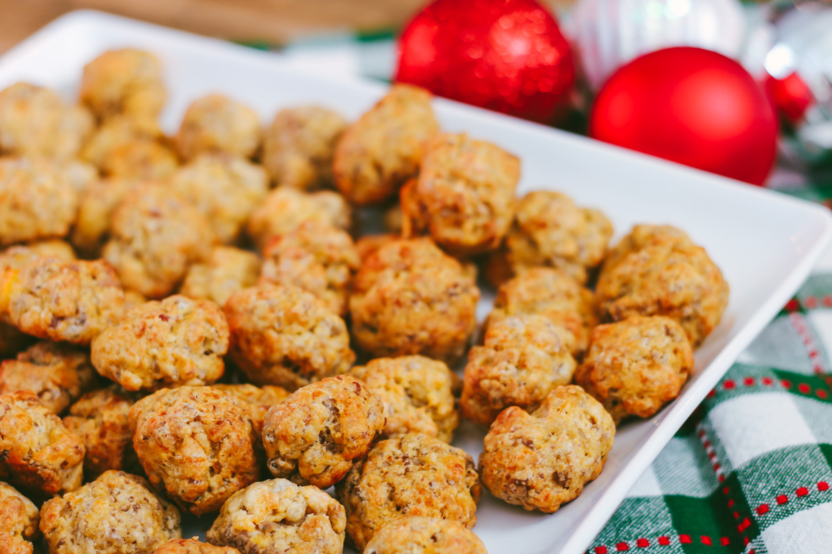 My sausage balls recipe made with Bisquick, pork sausage and cheddar is a favorite holiday appetizer and a big hit with guests. They continue to be one of my most-requested holiday recipes! Serve sausage balls at your next holiday party.