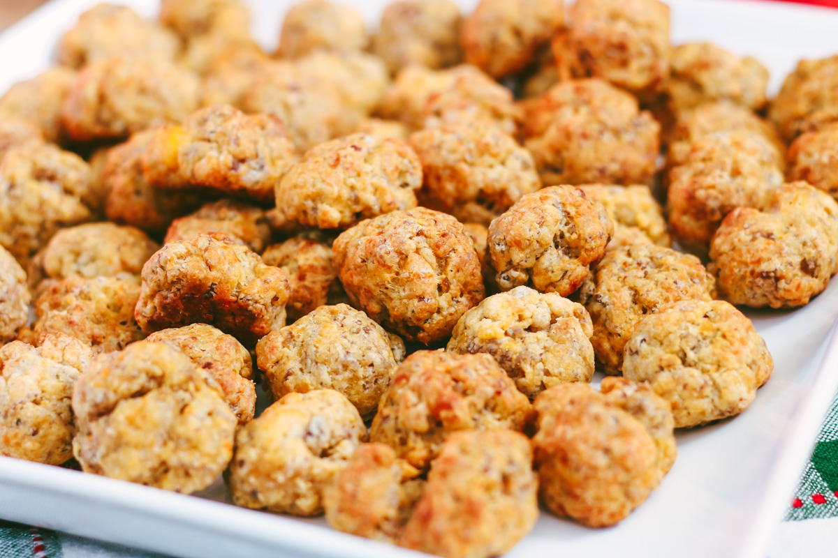 My sausage balls recipe made with Bisquick, pork sausage and cheddar is a favorite holiday appetizer and a big hit with guests. They continue to be one of my most-requested holiday recipes! Serve sausage balls at your next holiday party.